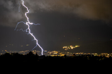 Lightning strikes the city at night, storm.