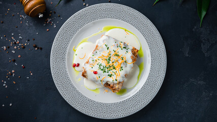 Lasagna with bechamel sauce, bolognese and greens.