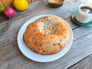 Bread on a white plate in a natural style., with a cup of coffee. High quality photo