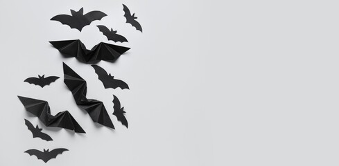 Black paper bats for Halloween party on grey background with space for text