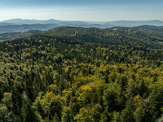 Fototapeta premium Beskid Maly aerial panorama of potrojna hill and czarny gron.Little Beskids mountain range in summer.Aerial drone view of Rzyki Village in Beskid Maly Poland.Czarny gron ski resort in Rzyki.