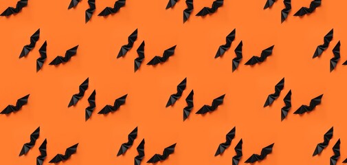 Many black paper bats for Halloween party on orange background