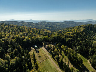 Obraz premium Beskid Maly aerial panorama of potrojna hill and czarny gron.Little Beskids mountain range in summer.Aerial drone view of Rzyki Village in Beskid Maly Poland.Czarny gron ski resort in Rzyki.