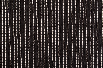Black fabrick with white stitches background texture