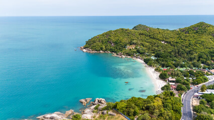 aerial drone shot of silver beach, koh samui, thailand. turquoise water, white sand, palm trees, and lush greenery create a serene tropical paradise, perfect for travel and tourism imagery.
