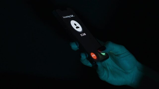 A hand hesitates over a phone screen showing an incoming "SCAM" call, considering whether to answer or reject it.