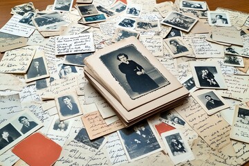 A vintage postcard collection, featuring old black-and-white photos and hand-written messages from the past