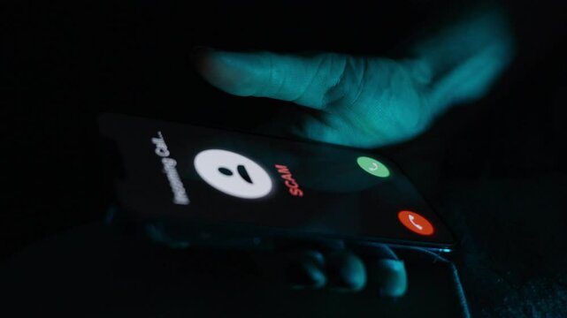A hand holds a phone showing an incoming "SCAM" call, highlighting hesitation to answer or reject.