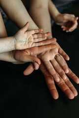 An expressive display of intergenerational connection through hands, revealing stories of love, support, and family unity in a warm, humble setting