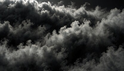 Obraz premium Dense, dark clouds forming a dramatic and moody sky background.