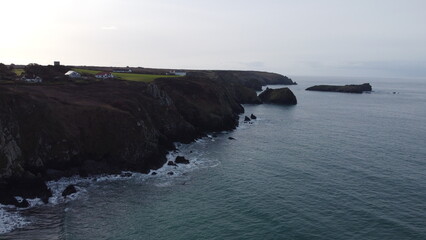 Aerial View of Rugged Coastline with Cliffs and Ocean Waves