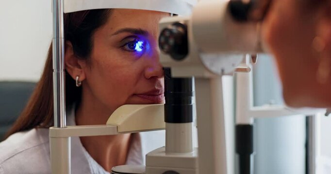 Eye, test and woman at machine with light for medical assessment, evaluation or retina check. Glaucoma, led glow and girl in exam for vision, focus or eyesight scan with health consultant at clinic