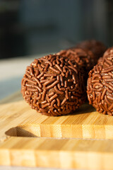 Close-up of Brazilian brigadeiros, a chocolate treat covered in sprinkles.