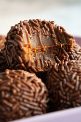 Close-up of a bite taken out of a chocolate brigadeiro, a popular Brazilian dessert.