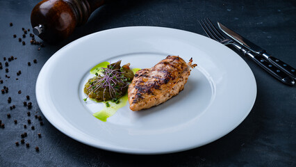 Chicken fillet with salad of pickled cucumbers, jalapeno peppers and microgreens.