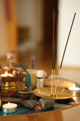 Evening meditation at home with candles, incense stick, pyramid of zen stones. The concept of relaxation. Close up.