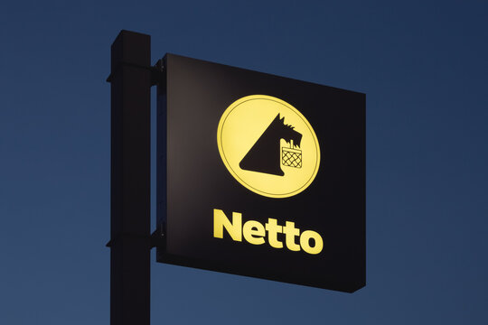 Tarnowo Podgorne, Poland - September 23, 2024. Netto stores logo with an evening sky background. Netto is a Danish chain of discount supermarkets owned by the Salling Group.
