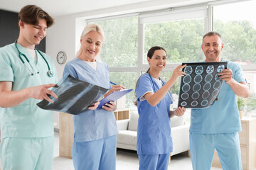 Team of doctors studying x-ray images in clinic