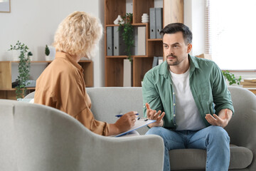 Young man visiting psychologist in office