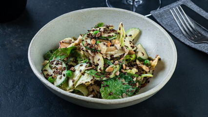 Green salad with cucumbers, lettuce, spinach, green peas, flax seeds and pumpkin.