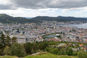 Fototapeta premium Panoramic View of the City and Mountains surrounding Bergen Norway from Atop Mount Fløyen at the Fløibanen Funicular Station