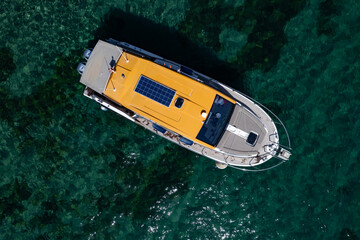 drone view of a luxury motor yacht in a beautiful clear sea.