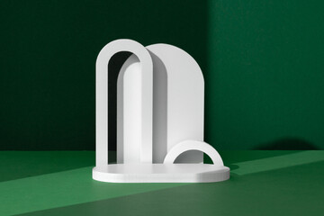 Modern White Architectural Shapes Against A Deep Green Background Displayed On A Simple Table...
