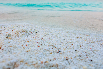 The beach is covered in white sand and the water is blue