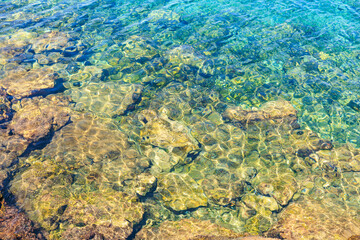 The water is clear and the rocks are brown