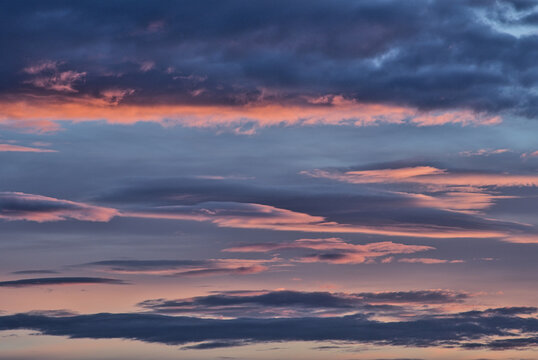 Clouds at sunset in blue and peach colors