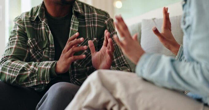 African couple, hands and conflict on sofa in home for disagreement, communication problem and relationship discussion. Man, woman and together with argument in house, emotional stress and dispute.