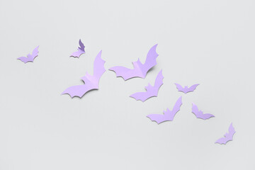 Lilac paper bats for Halloween party on grey background
