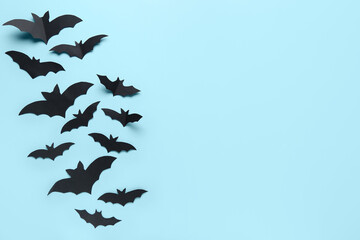 Fototapeta premium Many black paper bats for Halloween party on blue background