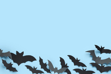 Paper bats for Halloween party on blue background