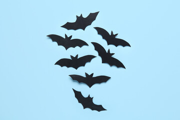 Many black paper bats for Halloween party on blue background