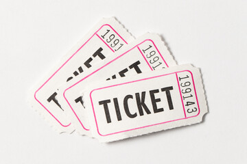 Three white vintage admission tickets