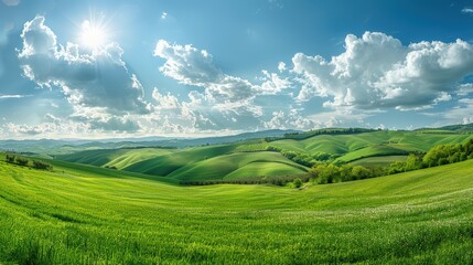 Obraz premium Landscape of rolling hills, picturesque countryside with green fields and scenic meadows, rural farmland in a sunny summer morning.