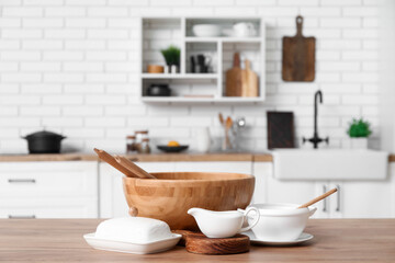 Wooden bowl and porcelain dishes on counter in kitchen
