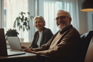 Elderly Duo Sharing a Joyful Moment While Working on a Laptop in a Cozy Indoor Setting