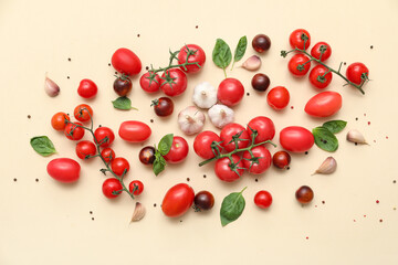Fresh ripe tomatoes with garlic, basil and peppercorn on beige background