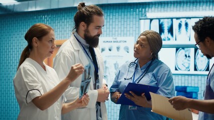 Fototapeta premium Doctors and radiologists review human anatomy scans to develop treatment service. Doing teamwork and expertise in radiology and diagnostics for correct healthcare solutions. Camera A.