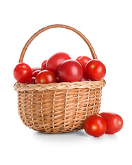 Wicker basket with fresh ripe tomatoes on white background