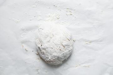Overhead view of bread dough filled with date jam on a parchment lined baking tin, top view of proofed dough, process of making date jam filled bread