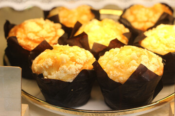 Muffins on plate placed on a wooden table.