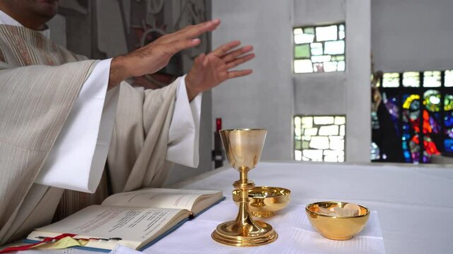 Priest praying over offerings during mass in a Catholic church.