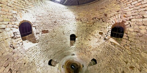 Exploring the deep, ancient Roman well at belgrade fortress, with its spiral steps and barred windows, reveals the city's rich history and cultural heritage , built in 18th century