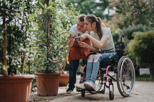 A young man with Down syndrome and a woman in a wheelchair engage in gardening. The image showcases teamwork, inclusion, and outdoor activity in a beautiful garden setting.