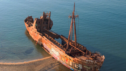 greece peloponnese region sunken ship stuck on the beach rusty old metal formerly used for transportation and trade