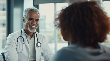 Fototapeta premium Smiling doctor speaking with patient in a consultation room