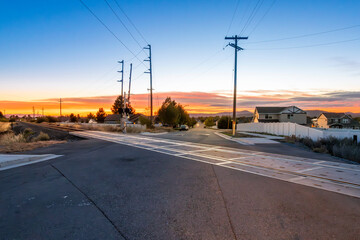 Sunset view of a rural residential community near railroad train tracks in the countryside prairie area of Coeur d'Alene, Idaho, USA.